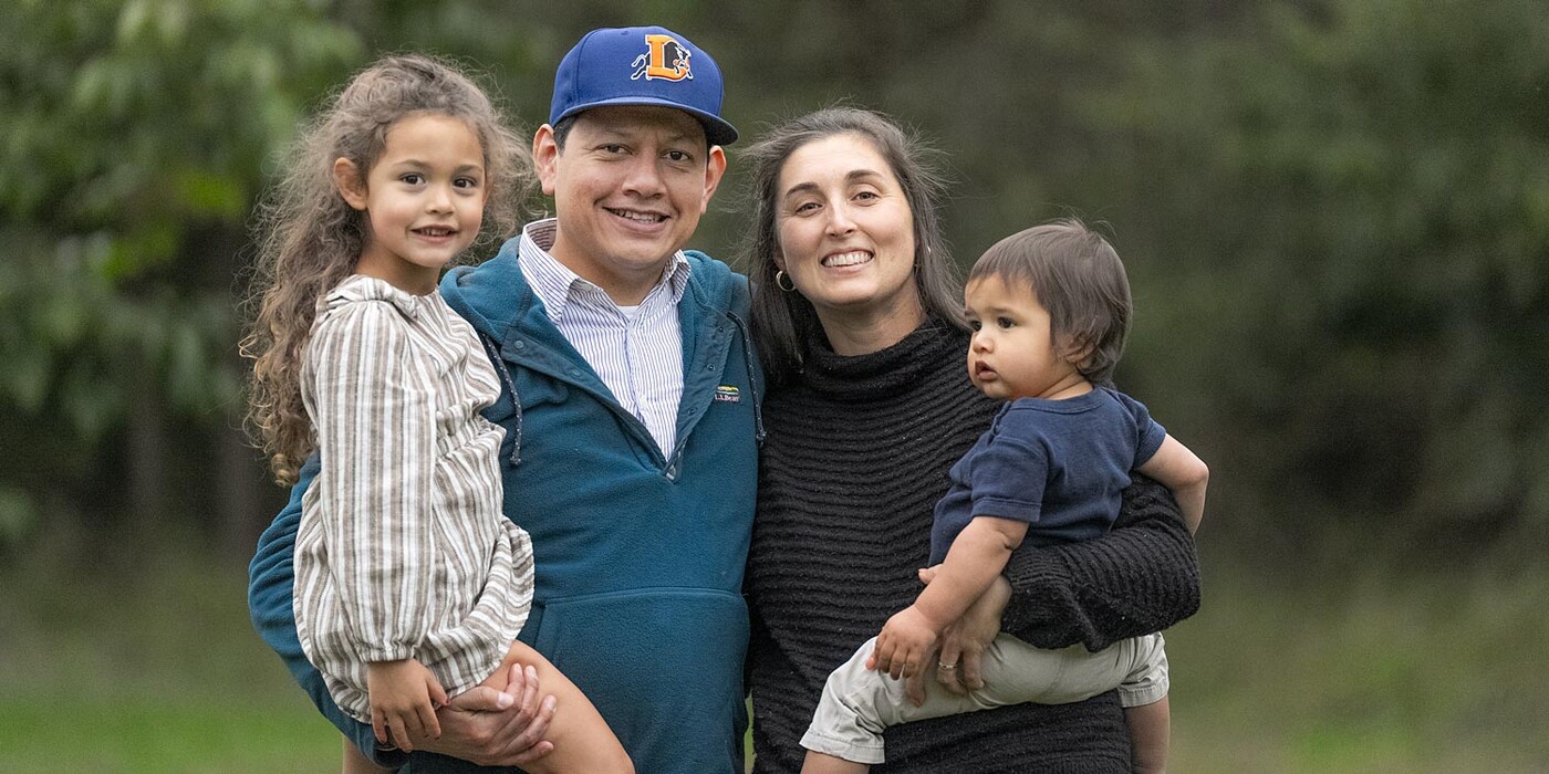 The Bellido family smiles together at a park in Durham, NC. The Bellido family smiles for a photo outside